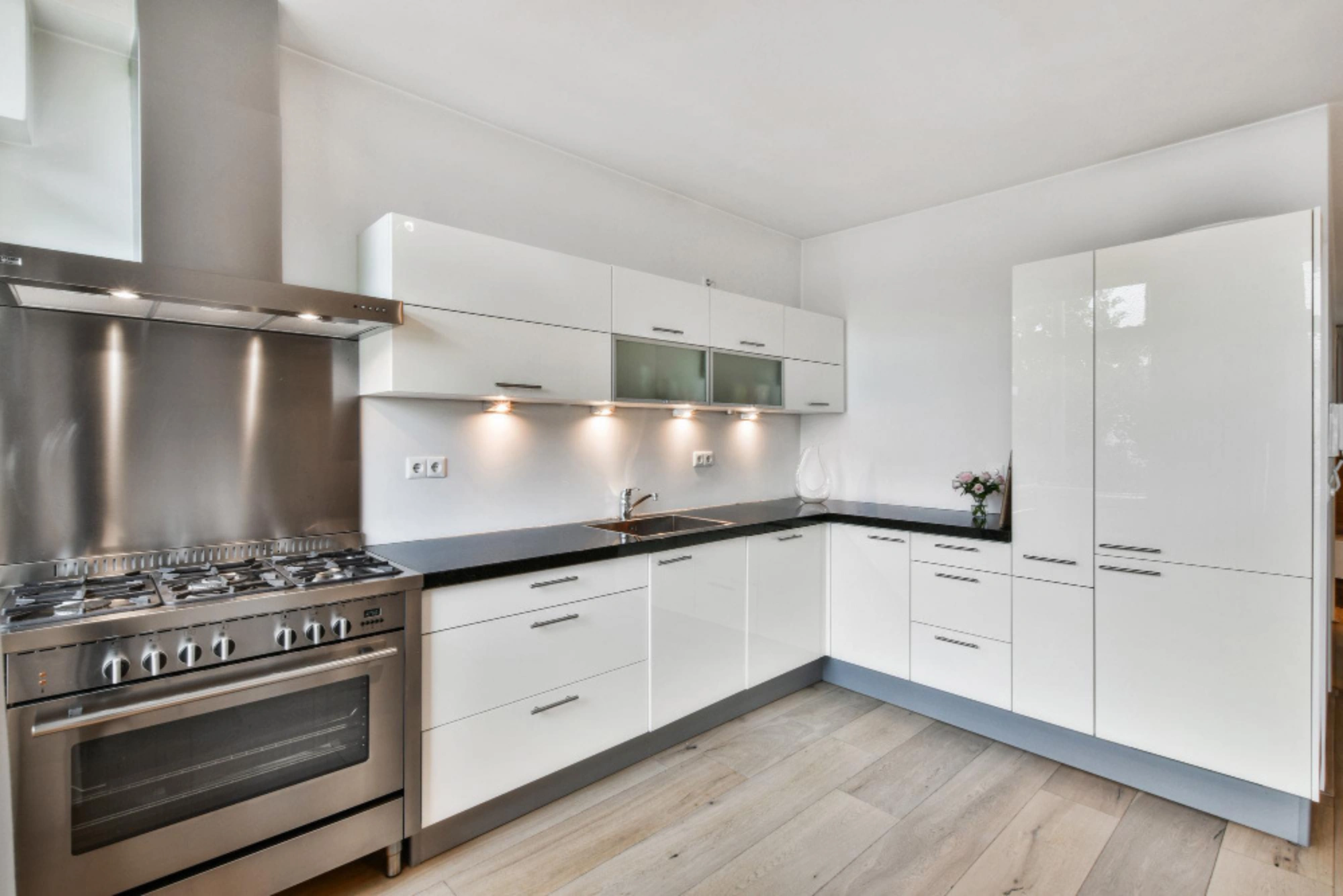 Modern kitchen renovation featuring custom cabinetry and premium countertops